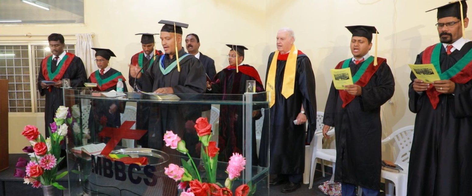 Faculty in academic gowns at an MBBCS graduation service